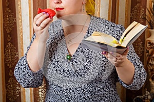 A Jewish woman sniffs bsamim spices after Shabbat while holding a siddur.