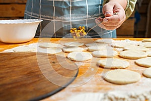 Jewish women's hands lay out poppy seeds filling for Haman's ears for the holiday of Purim