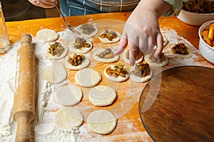 Jewish women& x27;s hands lay out poppy seeds filling for Haman& x27;s ears for the holiday of Purim