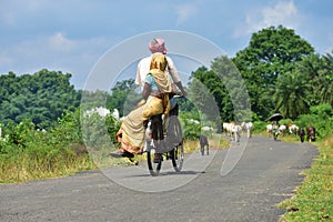 Jhargram, West Bengal , India - Senior old Indian Couple On Cycle Ride In Countryside in rural India