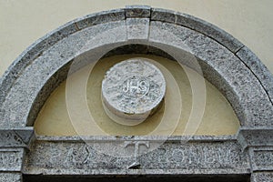 JHS Christogram of the stone above the lateral entrance of church of San Francesco, Albania photo