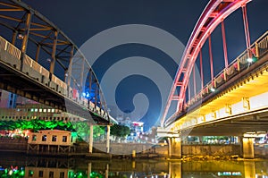 Jiangmen, Guangdong, China, the Jiangmen Iron bridgeLeft and Shenglli bridgeRight at night.