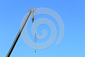 Jib of a construction crane during the daytime against a blue sky.