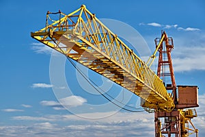 Jib crane tower against blue sky