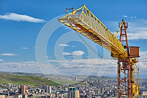 Jib crane tower against blue sky