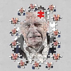 Jigsaw concept of mental illness or dementia with senior caucasian man weeping and alone
