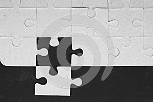 Missing jigsaw puzzle pieces in unfinished work.