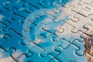 Jigsaw puzzle. Closeup of blue jigsaw puzzle peices. Conceptual photo with focus on completed puzzle