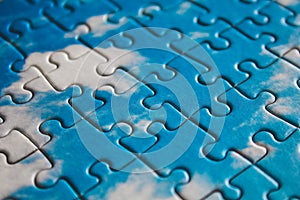 Jigsaw puzzle. Closeup of blue jigsaw puzzle peices. Conceptual photo with focus on completed puzzle
