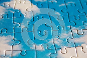 Jigsaw puzzle. Closeup of blue jigsaw puzzle peices. Conceptual photo with focus on completed puzzle