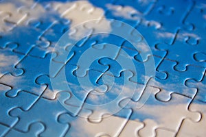 Jigsaw puzzle. Closeup of blue jigsaw puzzle peices. Conceptual photo with focus on completed puzzle