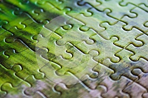 Jigsaw puzzle. Closeup of green jigsaw puzzle peices. Conceptual photo with focus on completed puzzle