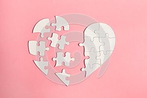 Jigsaw puzzle heart isolated on pink background, top view, flat lay, divorce, depression and breakup concept, crying, medical card