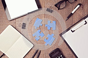 Jigsaw puzzle on office desk. Team collaboration concept photo