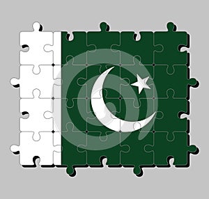 Jigsaw puzzle of Pakistan flag in a white star and crescent on a dark green field, with a vertical white stripe.