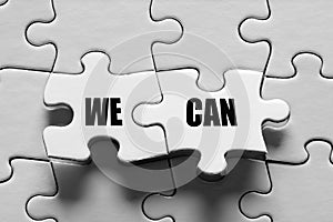 Jigsaw puzzle piece with the message we can. Togetherness, teamwork, solidarity, success and achievement