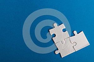 Jigsaw puzzle pieces on blue background