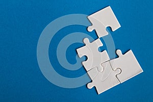 Jigsaw puzzle pieces on blue background