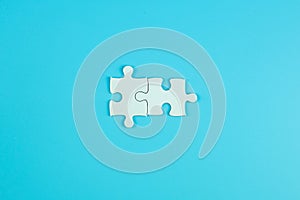 Jigsaw puzzle pieces on blue background with copy space for text. solutions, mission, successful, goals, cooperation, partnership