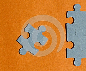 Jigsaw puzzle pieces on bright orange background