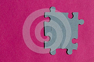 Jigsaw puzzle pieces on bright pink background