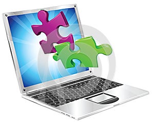 Jigsaw puzzle pieces flying out of laptop computer