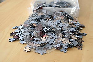 Jigsaw puzzle pieces out of the plastic bag