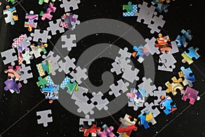 Jigsaw puzzle pieces put together on a black background