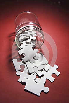 Jigsaw Puzzle Pieces Spilling From Glass Jar