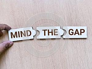 Jigsaw puzzle pieces with word mind the gap.