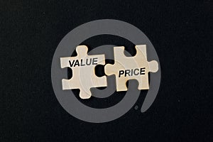 Jigsaw puzzle pieces with the word VALUE PRICE Business concept