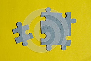 Jigsaw Puzzle pieces on yellow background