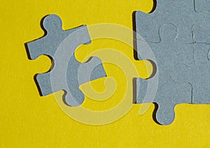 Jigsaw Puzzle pieces on yellow background