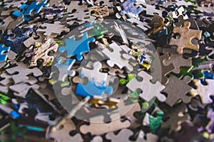 Jigsaw puzzle. Pile of jigsaw puzzle peices. Conceptual photo with focus on undone puzzle