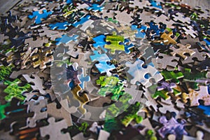 Jigsaw puzzle. Pile of jigsaw puzzle peices. Conceptual photo with focus on undone puzzle