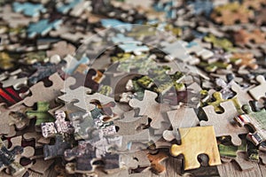 Jigsaw puzzle. Pile of jigsaw puzzle peices. Conceptual photo with focus on undone puzzle