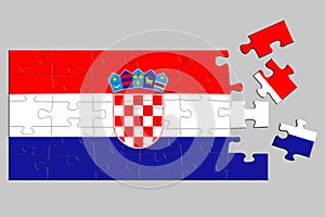 A jigsaw puzzle with a print of the flag of Croatia, some pieces of the puzzle are scattered or disconnected. Isolated background