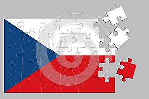 A jigsaw puzzle with a print of the flag of Czech, some pieces of the puzzle are scattered or disconnected. Isolated background.