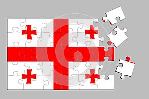 A jigsaw puzzle with a print of the flag of Georgia, some pieces of the puzzle are scattered or disconnected. Isolated background