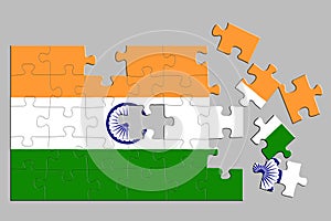 A jigsaw puzzle with a print of the flag of India, some pieces of the puzzle are scattered or disconnected. Isolated background.