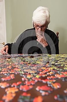 Jigsaw puzzle put together by an eldery woman photo