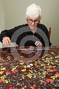 Jigsaw puzzle put together by an eldery woman photo