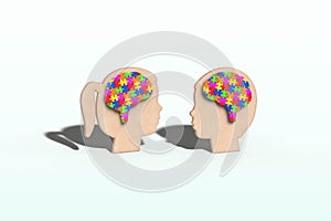 Jigsaw puzzle in the shape of a brain on girl and boy heads, colourful colours, childrenâ€™s education, development, mental health