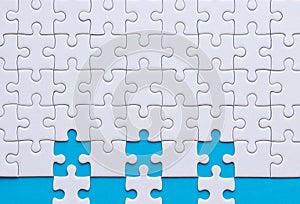 Jigsaw puzzle white color,Puzzles pieces grid,Success mosaic solution template,Horizontal on blue color background copy space for