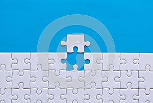 Jigsaw puzzle white color,Puzzles pieces grid,Success mosaic solution template,Horizontal on blue color background copy space for