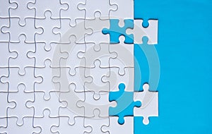 Jigsaw puzzle white color,Puzzles pieces grid,Success mosaic solution template,Horizontal on blue color background copy space for