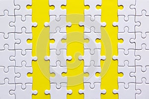 Jigsaw puzzle white color on yellow background,Row puzzle pieces grid,Success mosaic solution template