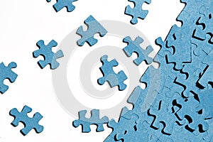 jigsaw puzzles on white background, partially assembled mosaic, many pieces of jigsaw puzzles, the concept of laborious work, fin