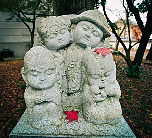 Jizo Buddha with coloful red maple leaves