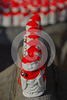 Jizo with red hats lining up